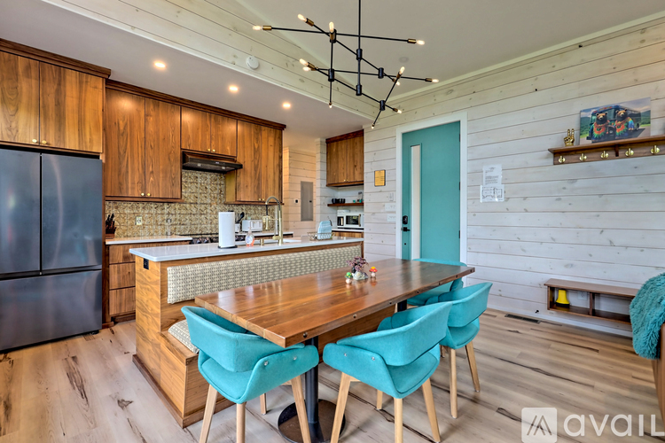 A kitchen with a table and chairs in the middle of it.
