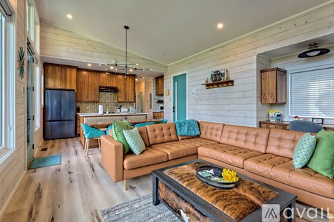 A living room with a brown couch and a wooden coffee table.