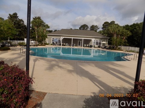 A pool with a house in the background and a date stamp of 06.04.2023 10:07.