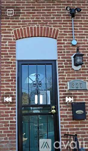 A black door with a glass window and a metal handle.