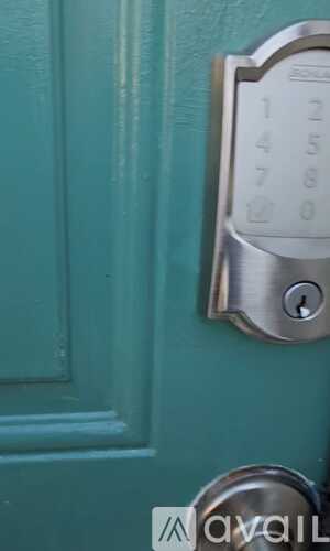 A keypad is on a door with a silver handle.