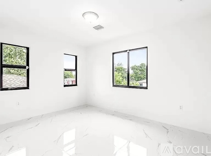 A room with two windows and a white ceiling.