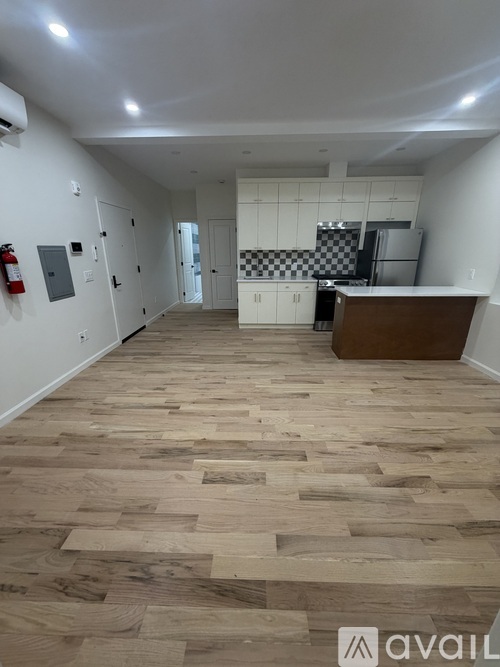 A room with wooden flooring and a checkered floor in the background.