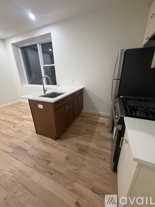 A kitchen with a sink and a window.