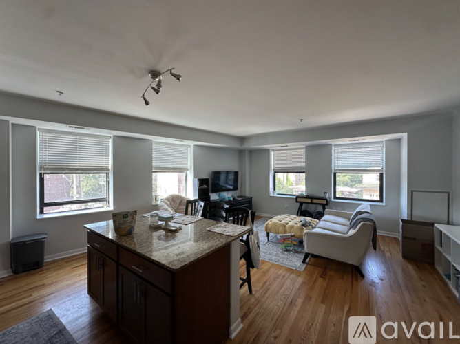 A room with wooden floors and a window with blinds.