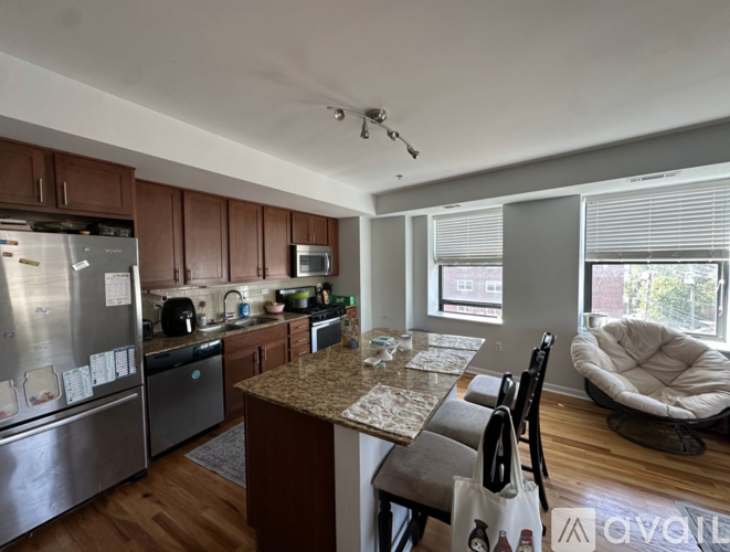 A room with wooden floors and two windows.