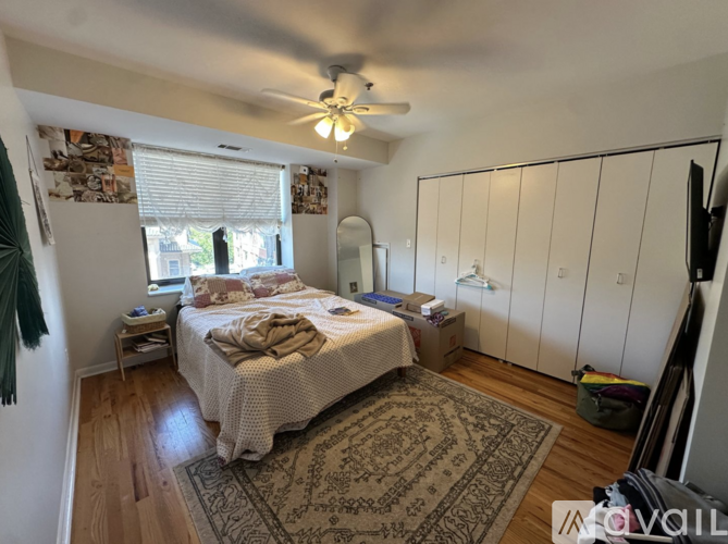 A spacious room with wooden floors and white walls.