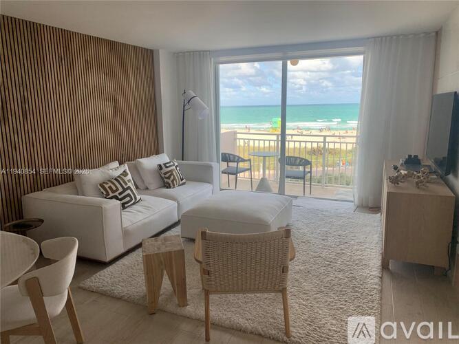 A living room with a view of the beach.