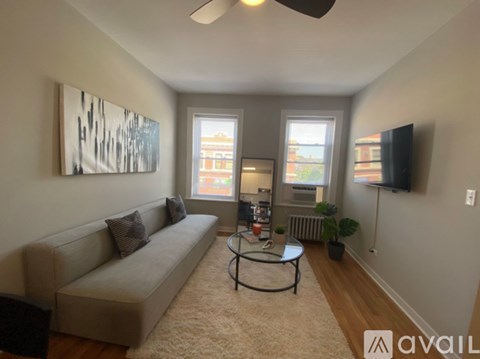 A room with wooden floors and a ceiling fan.