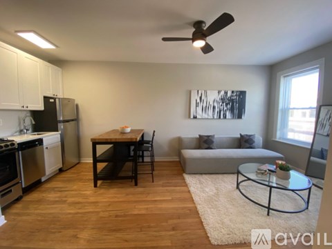 A room with wooden flooring and a white door.