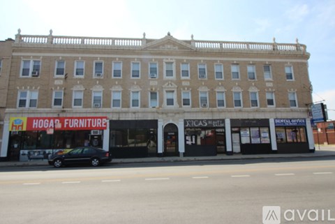A building with a sign that says "Hogan Furniture" on the front.