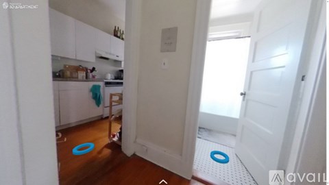A kitchen with white cabinets and a blue mat on the floor.