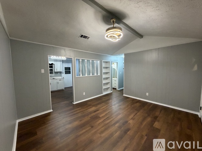 A room with wooden floors and a ceiling light.