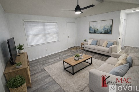A room with wooden floors and a ceiling light.