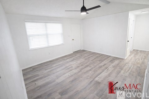 A room with wooden floors and grey walls.