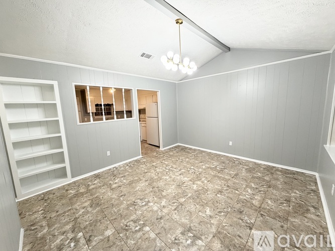 A room with a tiled floor and a window with blinds.