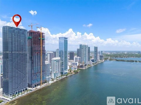 A cityscape with a red location marker on a building under construction.