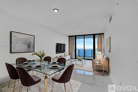 A modern dining room with a glass table and chairs.