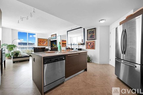 A modern kitchen with stainless steel appliances and a large island.
