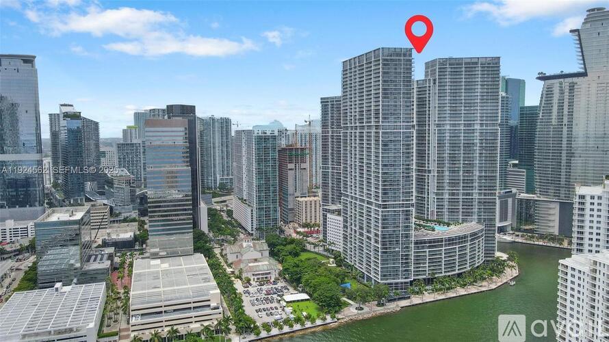 A red pin marks a location on a cityscape with tall buildings and a body of water.