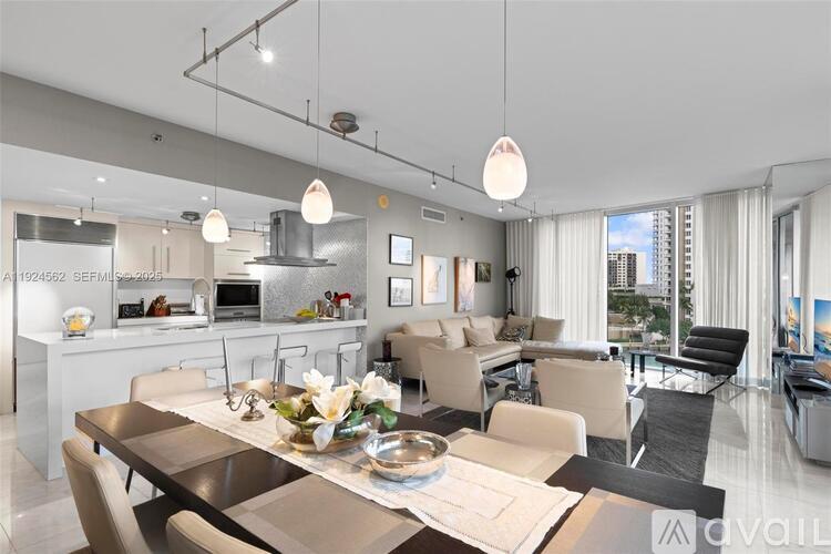 A modern kitchen with a dining table set for four.