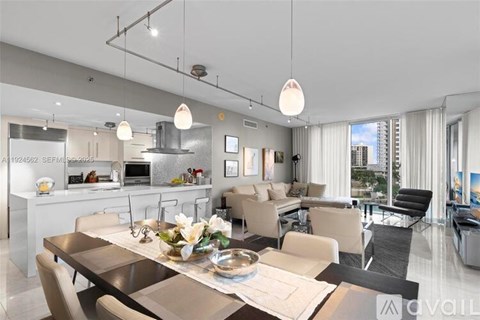 A modern kitchen with a dining table set for four.