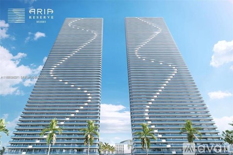 Two tall buildings with a zigzag pattern on the side are labeled ARIA RESERVE MIAMI.
