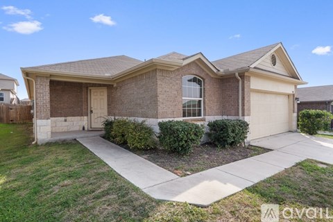 A house with a brown brick exterior and a white garage door.