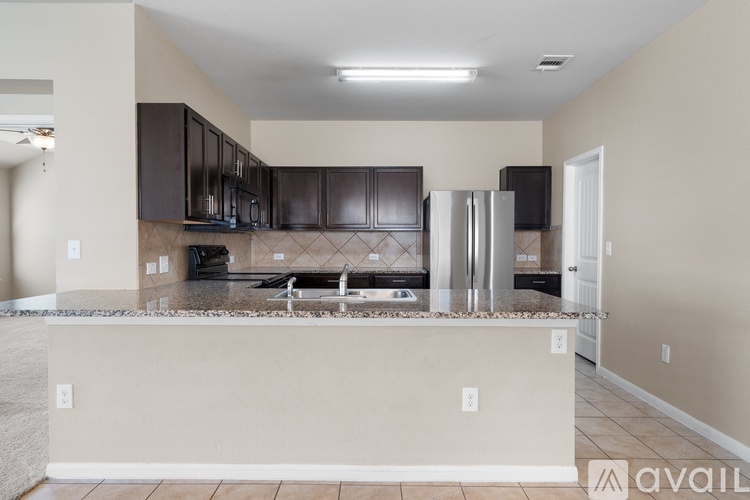 A kitchen with brown cabinets and a white island.
