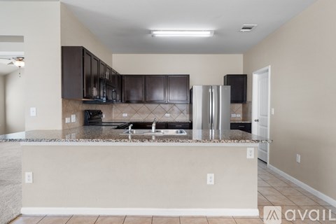 A kitchen with brown cabinets and a white island.
