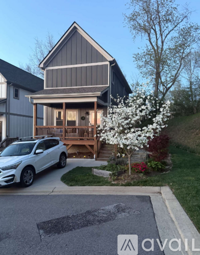 A house with a car parked in front of it.