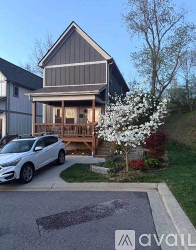 A house with a car parked in front of it.