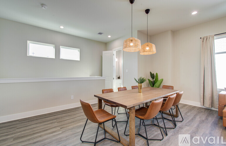 A dining room with a wooden table and chairs.