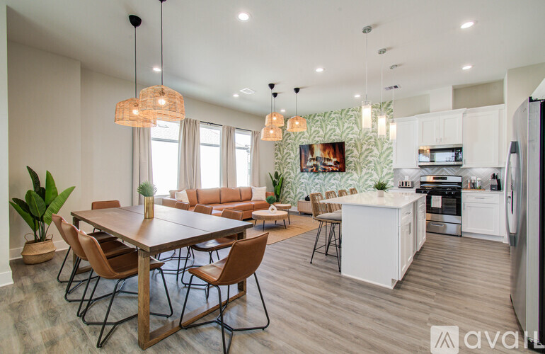 A modern kitchen with a dining table and chairs.