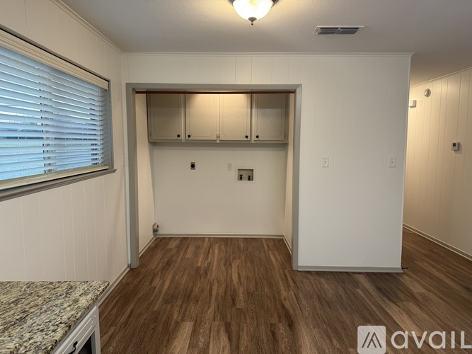 A room with wooden floors and a marble countertop.