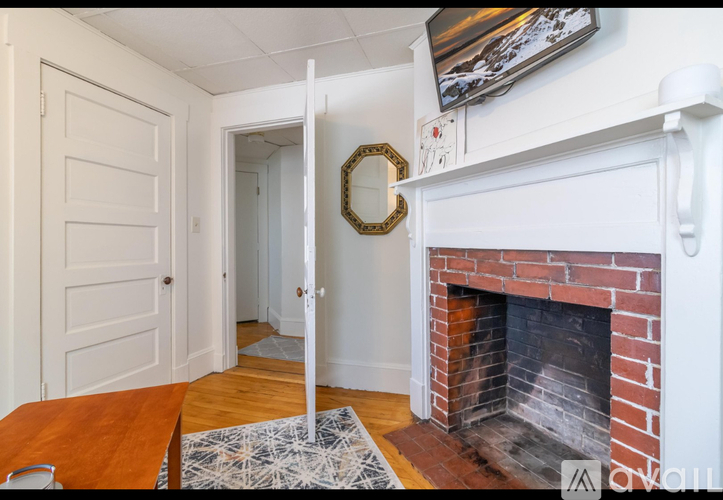 A white door is open to a hallway.