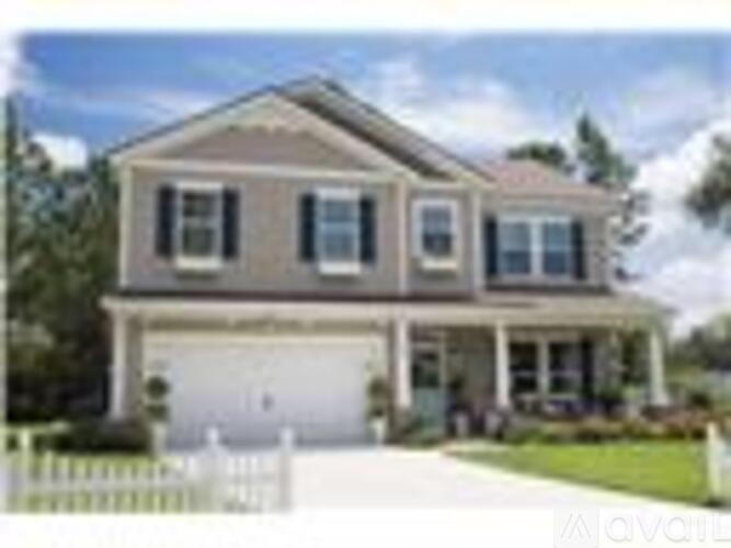 A two-story house with a garage is for sale.