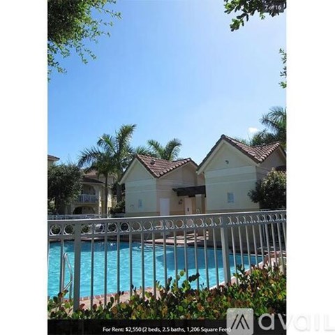 A pool in front of a house with a sign that says "available".