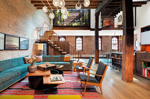 A living room with a blue couch and a wooden coffee table.