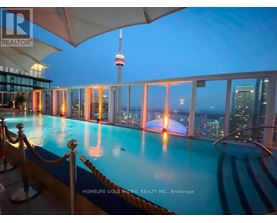A pool with a view of the city at night.