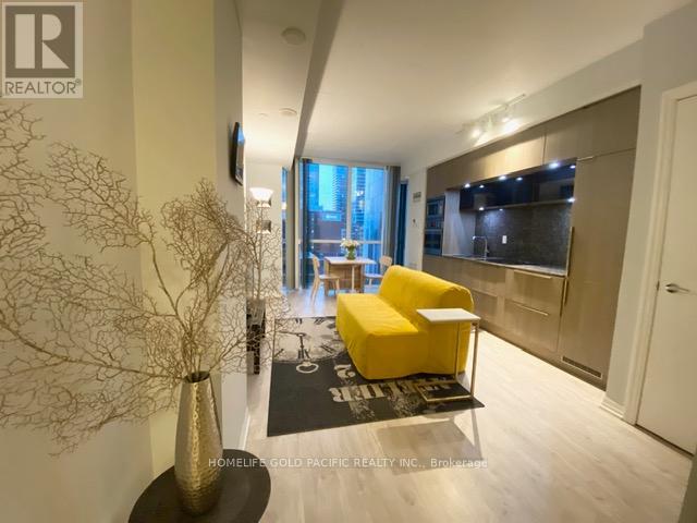A modern living room with a yellow chair and a large window.
