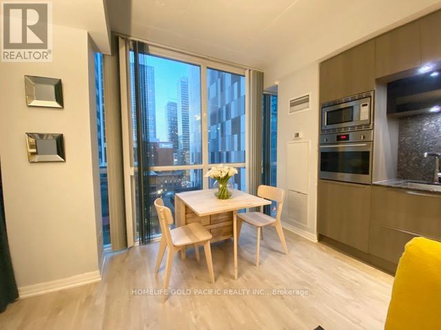 A dining room with a table set for two and a view of the city.
