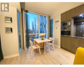 A dining room with a table set for two and a view of the city.