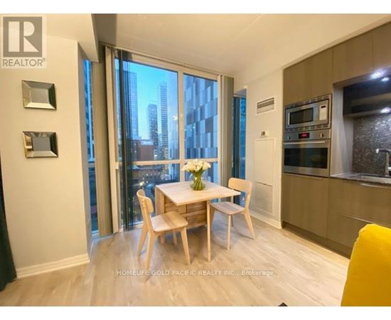 A dining room with a table set for two and a view of the city.