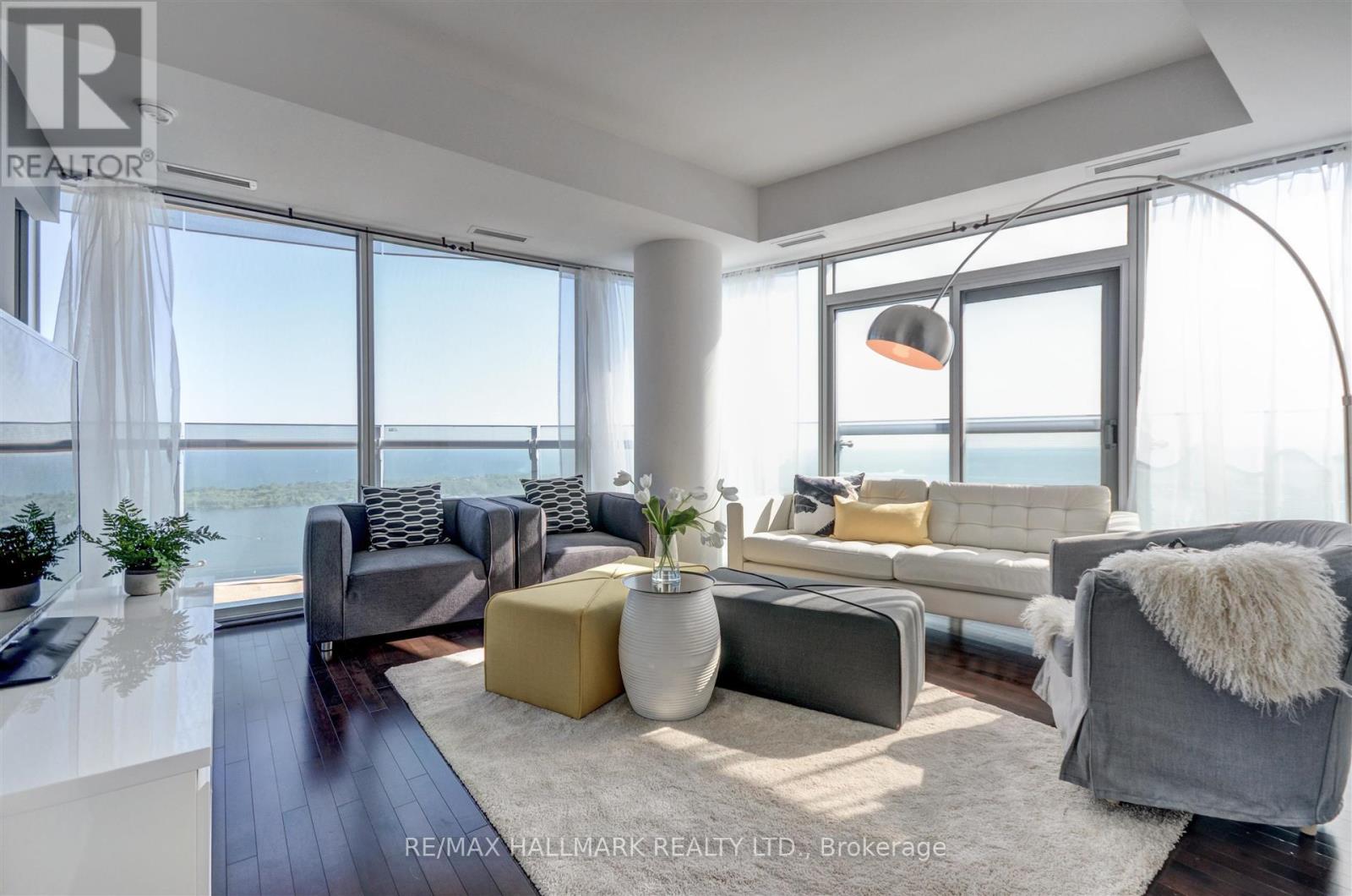 A modern living room with a view of the water.