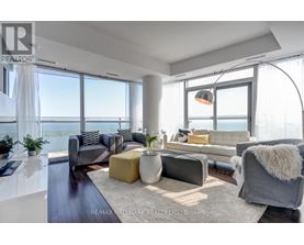 A modern living room with a view of the water.