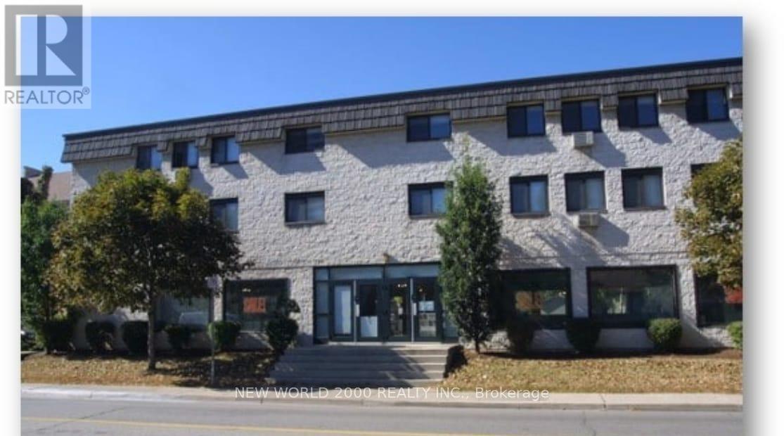 A building with a stone facade and a glass entrance.