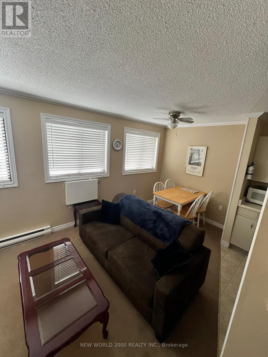 A living room with a brown couch and a wooden coffee table.