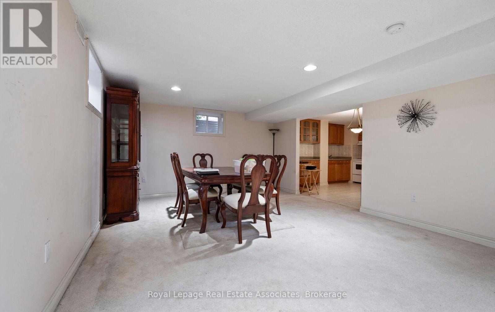 A dining room with a table and chairs.