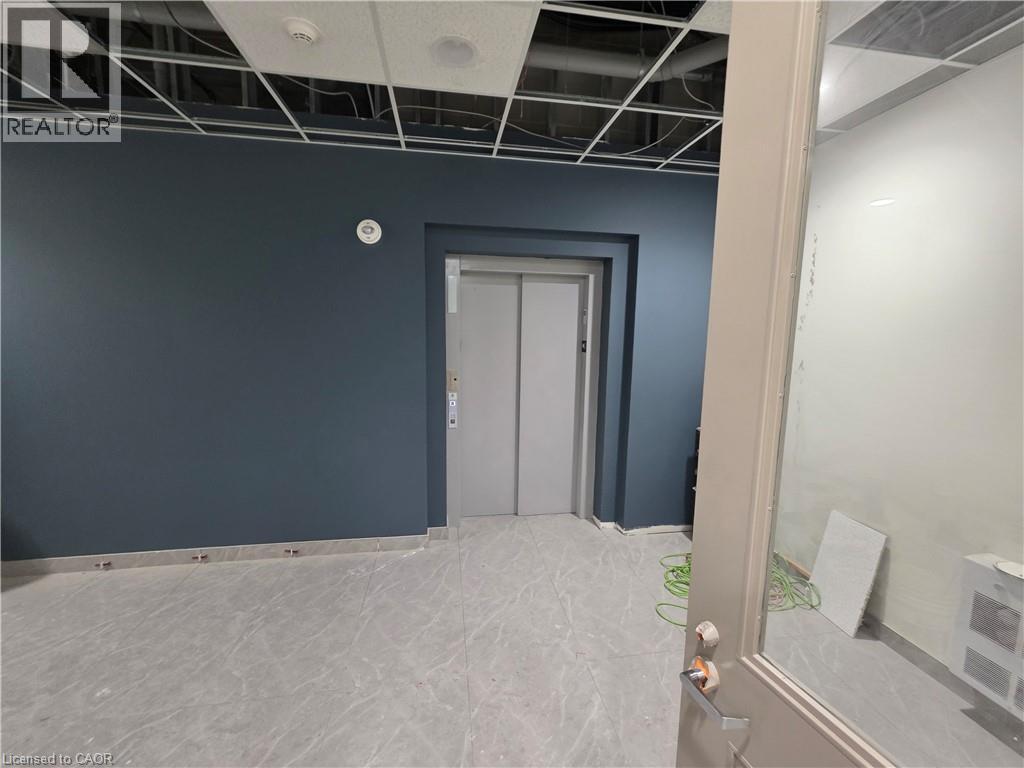 A room with a door and a wall with a hole in it.